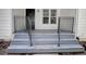 Close-up of the home's front porch and stairway with metal handrails and white siding at 2773 Hawk Trace Ne Ct, Marietta, GA 30066