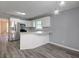 Modern kitchen with stainless steel appliances, white cabinets, and wood flooring at 2773 Hawk Trace Ne Ct, Marietta, GA 30066