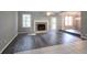 Open living room with a fireplace, gray walls, and wood flooring, leading to the dining room at 2773 Hawk Trace Ne Ct, Marietta, GA 30066