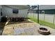 Outdoor patio with a dining table, fire pit, and privacy fence, perfect for entertaining and relaxation at 420 Ashbury Cir, Dallas, GA 30157