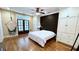 Spacious bedroom with a cozy hammock chair, built-in wardrobes, and hardwood floors, offers a relaxing retreat at 420 Ashbury Cir, Dallas, GA 30157