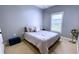 Comfortable bedroom with soft gray walls, neutral bedding, a window, and a stylish fan at 420 Ashbury Cir, Dallas, GA 30157