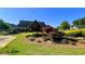 Stately clubhouse featuring manicured landscaping, beautiful flowering plants, and mature trees at 420 Ashbury Cir, Dallas, GA 30157