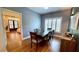 Dining room with wood floors, view into bedroom, and shutters on the windows at 420 Ashbury Cir, Dallas, GA 30157