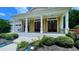 Charming front porch with yellow shutters and swing chairs at 420 Ashbury Cir, Dallas, GA 30157