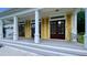Inviting front porch with yellow shutters, white columns, and seating, creating a welcoming entrance to the home at 420 Ashbury Cir, Dallas, GA 30157