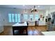 Modern kitchen with wood floors, island with seating, stainless steel appliances, and bright white cabinetry at 420 Ashbury Cir, Dallas, GA 30157
