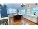 Modern kitchen with wood floors, island with seating, stainless steel appliances, and bright white cabinetry at 420 Ashbury Cir, Dallas, GA 30157