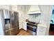 Modern kitchen featuring stainless steel appliances, white cabinets, and stone countertops at 420 Ashbury Cir, Dallas, GA 30157