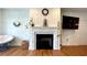 Cozy living room featuring a fireplace with white mantel and hardwood floors, creating a warm and inviting space at 420 Ashbury Cir, Dallas, GA 30157