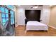 Main bedroom with wood floors, ensuite, accent wall, and natural lighting at 420 Ashbury Cir, Dallas, GA 30157