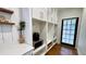 Mudroom with white cabinets, counter, and microwave space with a door leading to the outside at 420 Ashbury Cir, Dallas, GA 30157