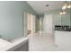 Bright bathroom with shower, tub, white cabinets, and a double vanity at 5035 Foxberry Ln, Roswell, GA 30075