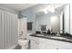 Bathroom featuring double sinks with a black granite countertop at 5035 Foxberry Ln, Roswell, GA 30075