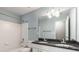 Bathroom featuring double sinks with a black granite countertop at 5035 Foxberry Ln, Roswell, GA 30075