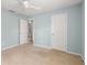 Empty bedroom with a door to the bathroom and neutral carpet at 5035 Foxberry Ln, Roswell, GA 30075