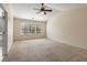 Bedroom with vaulted ceiling, ceiling fan, and large window with blinds at 5035 Foxberry Ln, Roswell, GA 30075