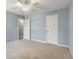 Bedroom features carpet, natural light, and a ceiling fan at 5035 Foxberry Ln, Roswell, GA 30075