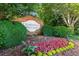 Community entrance sign surrounded by lush landscaping at 5035 Foxberry Ln, Roswell, GA 30075