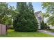 Residential house featuring a lush, mature tree creating a natural privacy screen in a well-maintained front yard at 5035 Foxberry Ln, Roswell, GA 30075