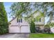 Charming two-story home featuring a two-car garage and well-manicured lawn, creating a welcoming curb appeal at 5035 Foxberry Ln, Roswell, GA 30075