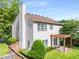 Charming home featuring a pergola-covered patio, well-manicured lawn and mature landscaping at 5035 Foxberry Ln, Roswell, GA 30075