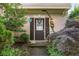 Welcoming front entrance with decorative wreath, blooming plants, and cozy lighting, showcasing home's curb appeal at 5035 Foxberry Ln, Roswell, GA 30075