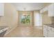 A kitchen and dining area with tiled floors, granite counters and chandelier at 5035 Foxberry Ln, Roswell, GA 30075
