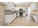 Eat-in kitchen featuring white cabinets, granite countertops, and stainless steel appliances at 5035 Foxberry Ln, Roswell, GA 30075