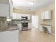 Bright kitchen featuring granite countertops, stainless steel appliances, and tile flooring at 5035 Foxberry Ln, Roswell, GA 30075