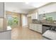 A kitchen and dining area with tiled floors, granite counters and stainless appliances at 5035 Foxberry Ln, Roswell, GA 30075