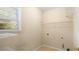 A small laundry room with a window and wire shelving at 5035 Foxberry Ln, Roswell, GA 30075