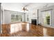 Spacious living room with hardwood floors, fireplace, and abundant natural light, offering a blank canvas for personalization at 5035 Foxberry Ln, Roswell, GA 30075