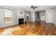 Living room with fireplace, hardwood floors, windows, and bright natural light at 5035 Foxberry Ln, Roswell, GA 30075