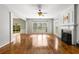 Bright living room featuring hardwood floors, fireplace, and large windows, creating an inviting and airy atmosphere at 5035 Foxberry Ln, Roswell, GA 30075