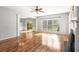 Bright living room featuring hardwood floors, fireplace, and large windows, creating an inviting and airy atmosphere at 5035 Foxberry Ln, Roswell, GA 30075