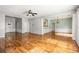 Open-concept living room featuring hardwood floors, ceiling fan, and natural light at 5035 Foxberry Ln, Roswell, GA 30075