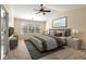 A well-furnished bedroom with a ceiling fan, lots of light, and an ensuite bathroom at 5035 Foxberry Ln, Roswell, GA 30075