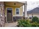 Inviting front porch with a charming bench, stone accents, and well-maintained landscaping at 963 Ensign Peak Ct, Lawrenceville, GA 30044