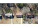 An aerial view shows a single Gathering home between other homes in the neighborhood at 11 Grove Ln, Hampton, GA 30228