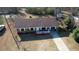 Aerial view showcases this brick single-Gathering home with white trim, complementing its well-manicured yard at 11 Grove Ln, Hampton, GA 30228