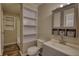 Well-organized bathroom with a mirrored vanity, built-in shelves, and modern fixtures at 11 Grove Ln, Hampton, GA 30228