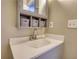 Modern bathroom vanity with a clean white sink, updated faucet, and convenient storage baskets at 11 Grove Ln, Hampton, GA 30228