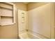 Clean and functional bathtub area with a built-in soap holder and tiled walls for easy maintenance at 11 Grove Ln, Hampton, GA 30228