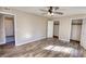 Bedroom with hardwood flooring, two closet doors and ceiling fan at 11 Grove Ln, Hampton, GA 30228