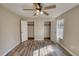 Bedroom with hardwood floors, two closet doors and neutral paint throughout at 11 Grove Ln, Hampton, GA 30228