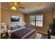 Bedroom with natural lighting, ceiling fan, and mountain art at 11 Grove Ln, Hampton, GA 30228