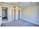 Relaxing bedroom with soft gray carpet, white trim, and a ceiling fan, creating a comfortable retreat at 11 Grove Ln, Hampton, GA 30228