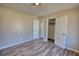 Bedroom featuring hardwood flooring and closet doors at 11 Grove Ln, Hampton, GA 30228