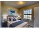 Cozy bedroom featuring a comfortable bed and calming artwork at 11 Grove Ln, Hampton, GA 30228
